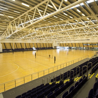 A photo of the grandstand seating overlooking the indoor courts at the Gold Netball Centre in Jolimont, Perth