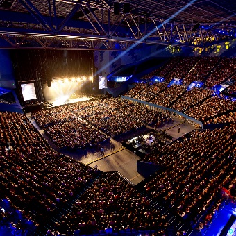 A high up photo from the crowd showing Elton John performing at RAC Arena in Perth