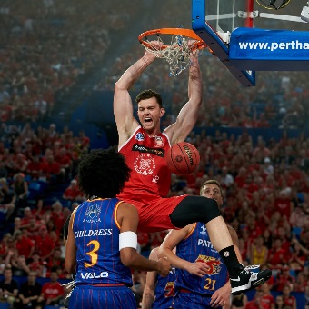 A close up photo of a Perth Wildcats player dunking during a game at RAC Arena in Perth