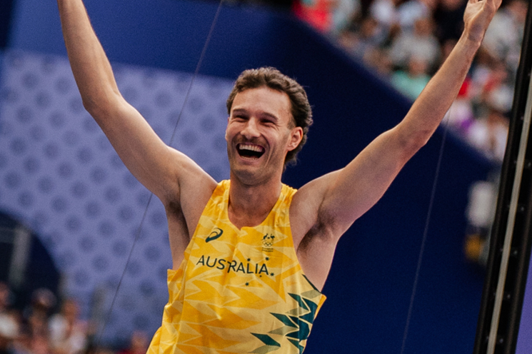 A photo of pole vault athlete Kurtis Marschall smiling and celebrating