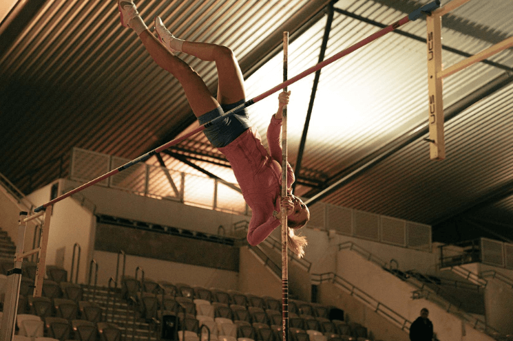 Photo of Maddi Lawson pole vaulting over the bar as part oof the Just Add Venue brand campaign