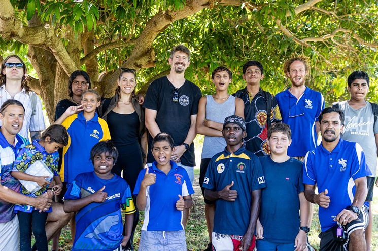 A group photo including members of the A Stitch in Time organisation alongside multiple youth participants