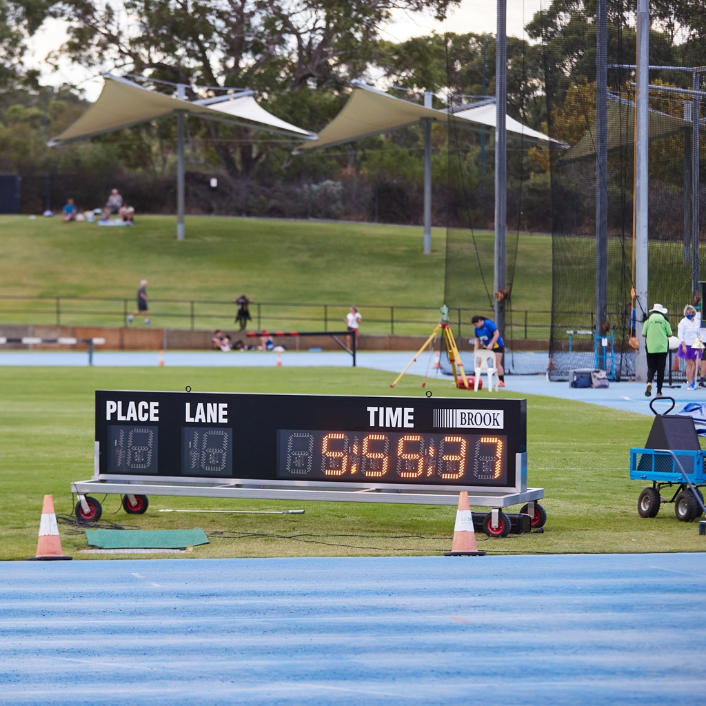 A photo of a timing scoreboard next to the track at the WA Athletics Stadium